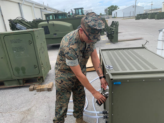 U.S. military serviceman drinking clean water from RussKap AWG unit.