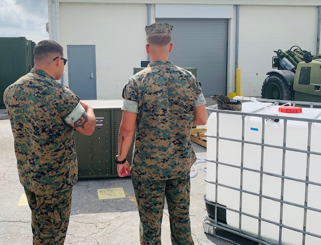 U.S. military servicemen drinking from RussKap AWG unit.