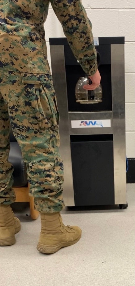 U.S. military serviceman utilizing RussKap AWG unit for high-quality drinking water.